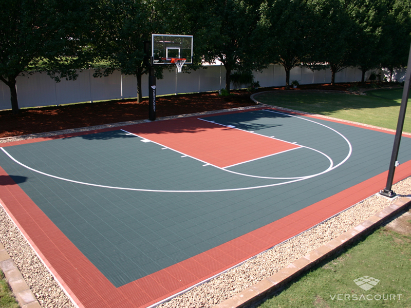 Green and red VersaCourt half court with a gravel border